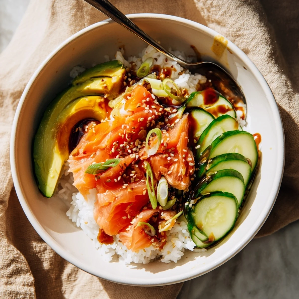 A delicious leftover salmon and rice bowl, topped with creamy avocado slices.  