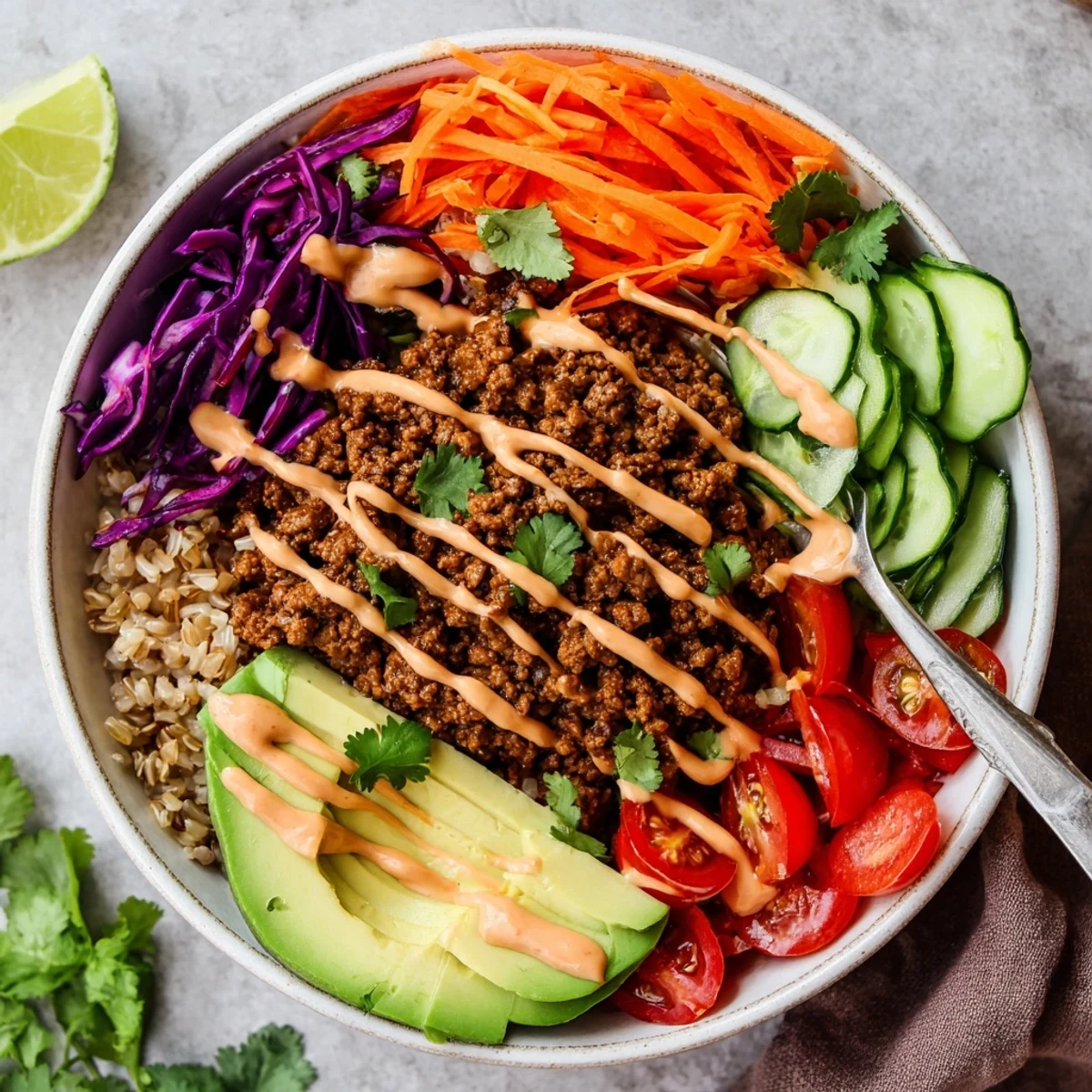 Vibrant plant-based meat bowl drizzled with spicy mayo for extra flavor.