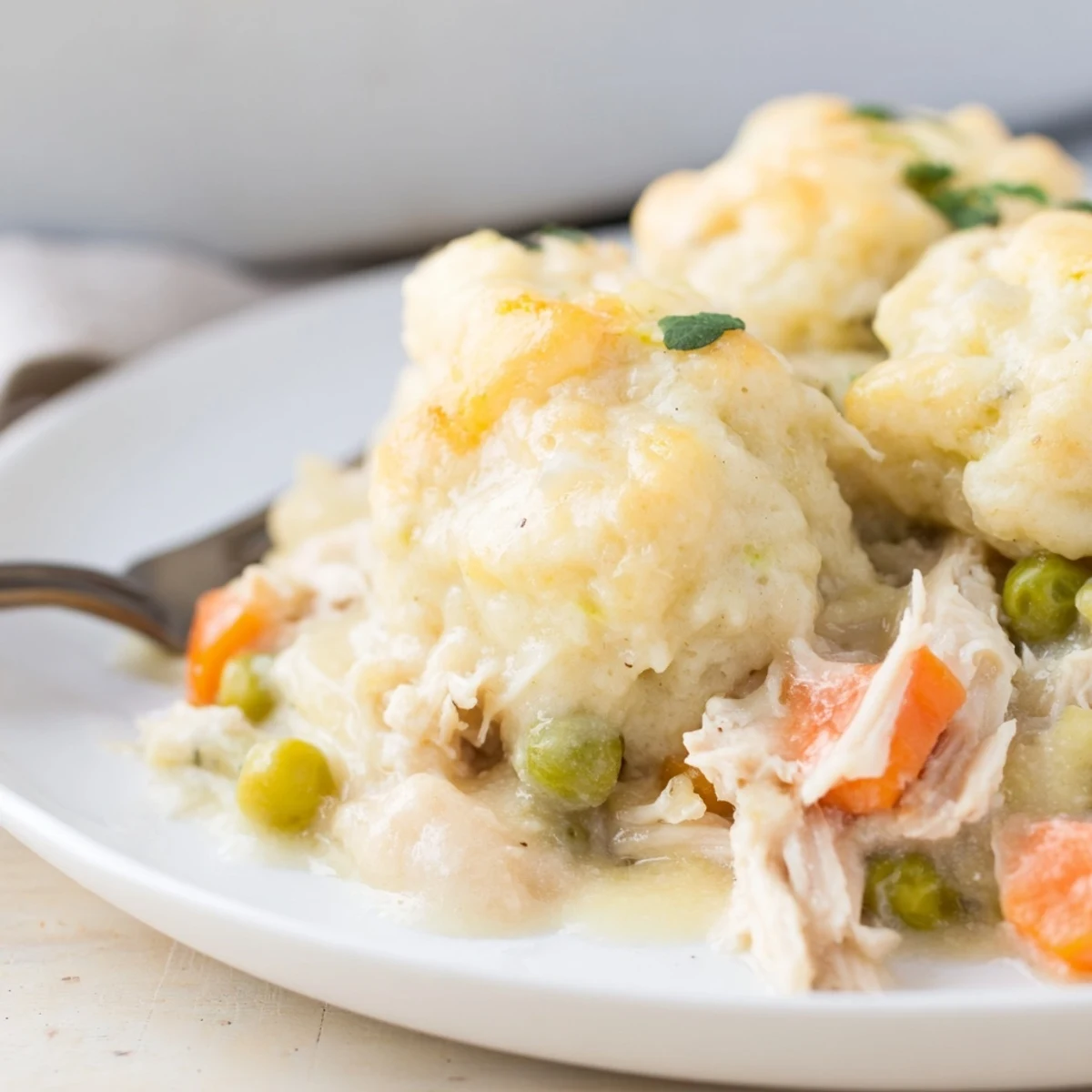 Savory Chicken and Dumplings Casserole with fluffy dumplings and fresh herbs.  