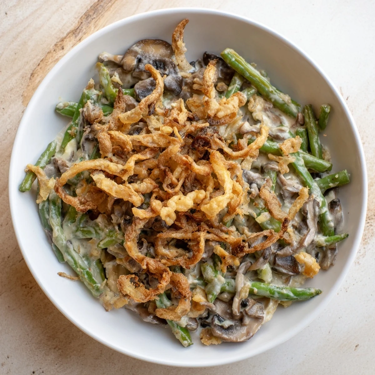 A bubbling, creamy Old-School Green Bean Casserole topped with crispy, golden fried onions.