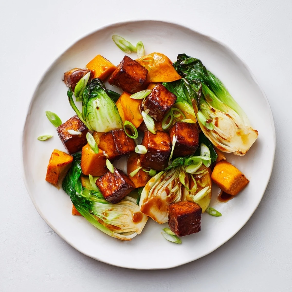 Savory miso glaze coats the caramelized tofu and squash, creating this flavorful Miso-Glazed Tofu entree.