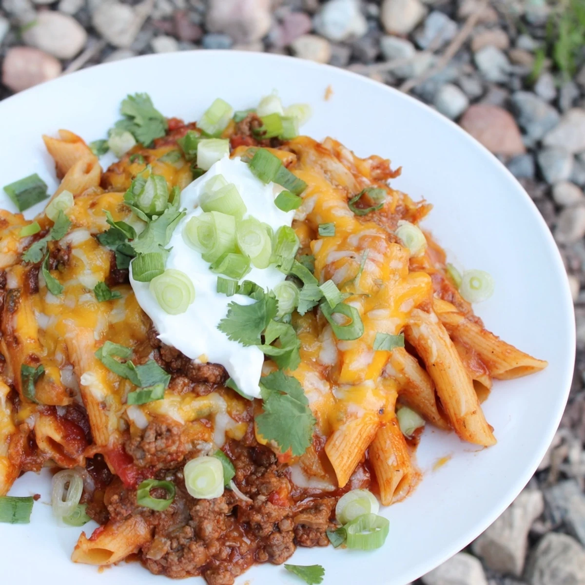 Easy Beef Enchilada Pasta, a one-pot meal, featuring melted cheese and a rich enchilada sauce.