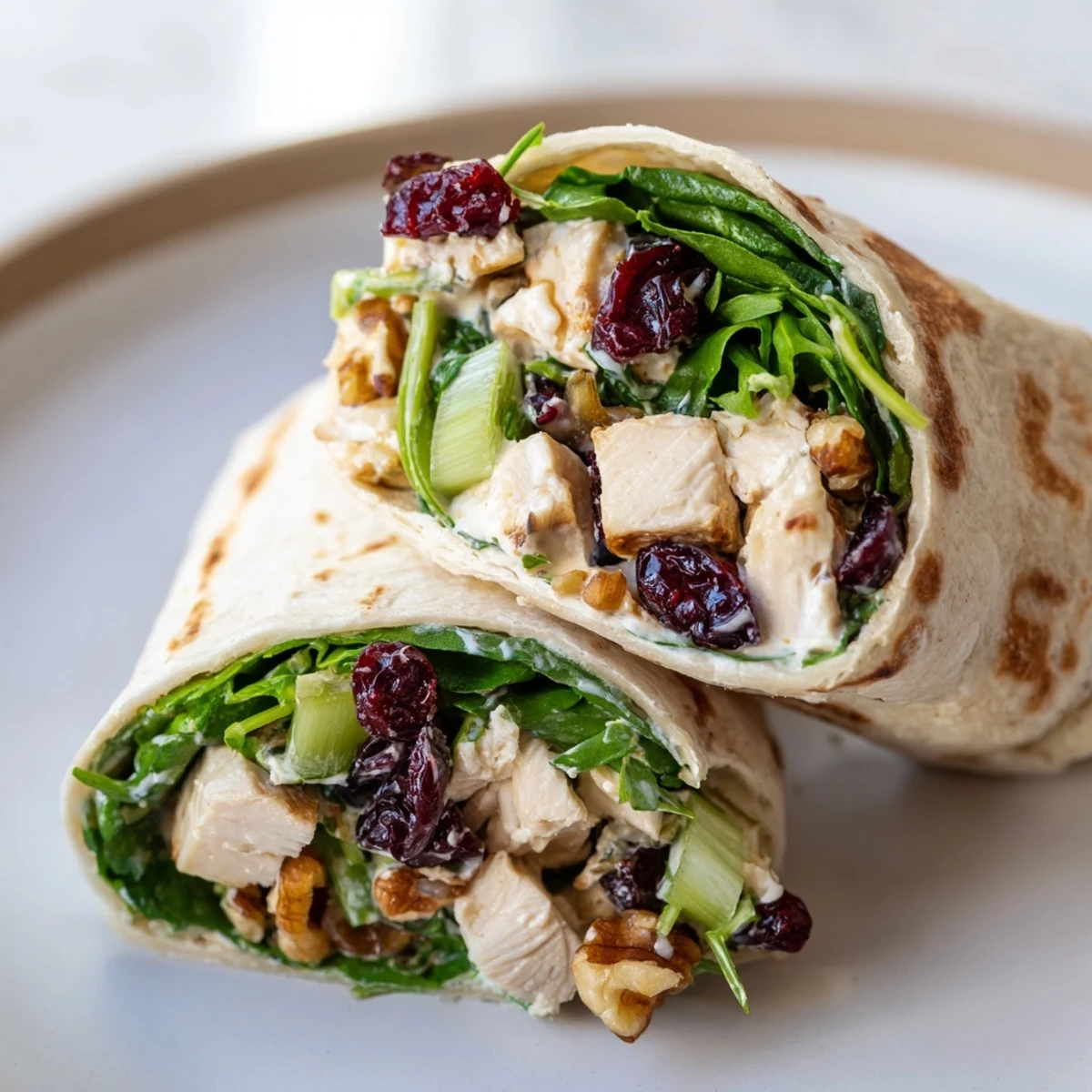 A beautifully arranged Christmas Wrap filled with creamy cranberry pecan chicken salad and fresh greens.
