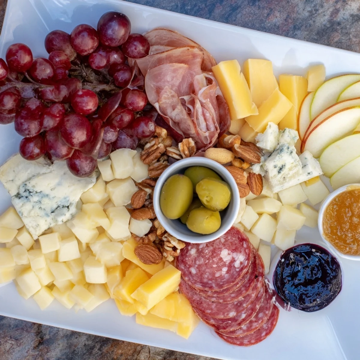 A beautifully arranged Moonlight Picnic Board, showcasing colorful fruits, cheeses, and meats for sharing.