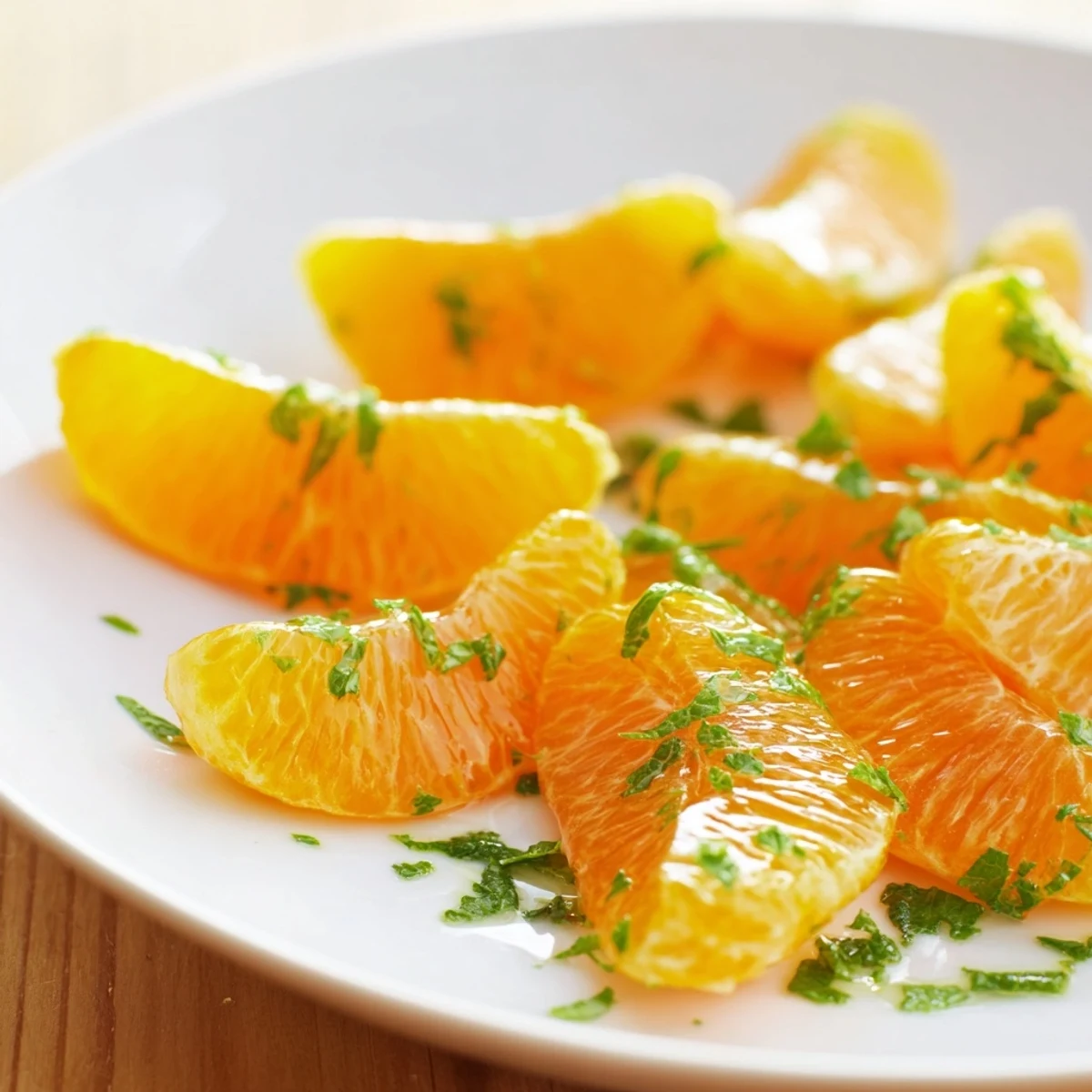 This bright Clementine and Mint Winter Fruit Salad includes fresh clementine segments and green mint.