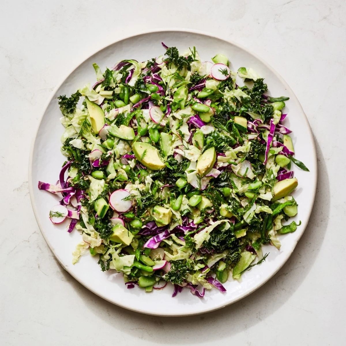 Vibrant Green Goddess Detox Cabbage Salad with crisp veggies, drizzled in zesty, bright dressing.