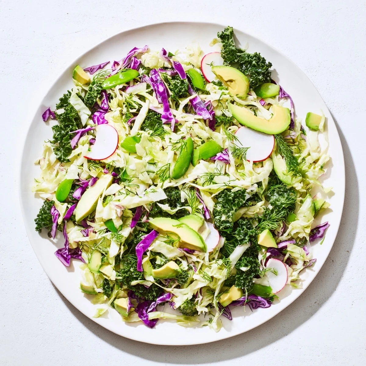 A healthy serving of Green Goddess Detox Cabbage Salad; a flavorful vegan bowl with fresh herbs.