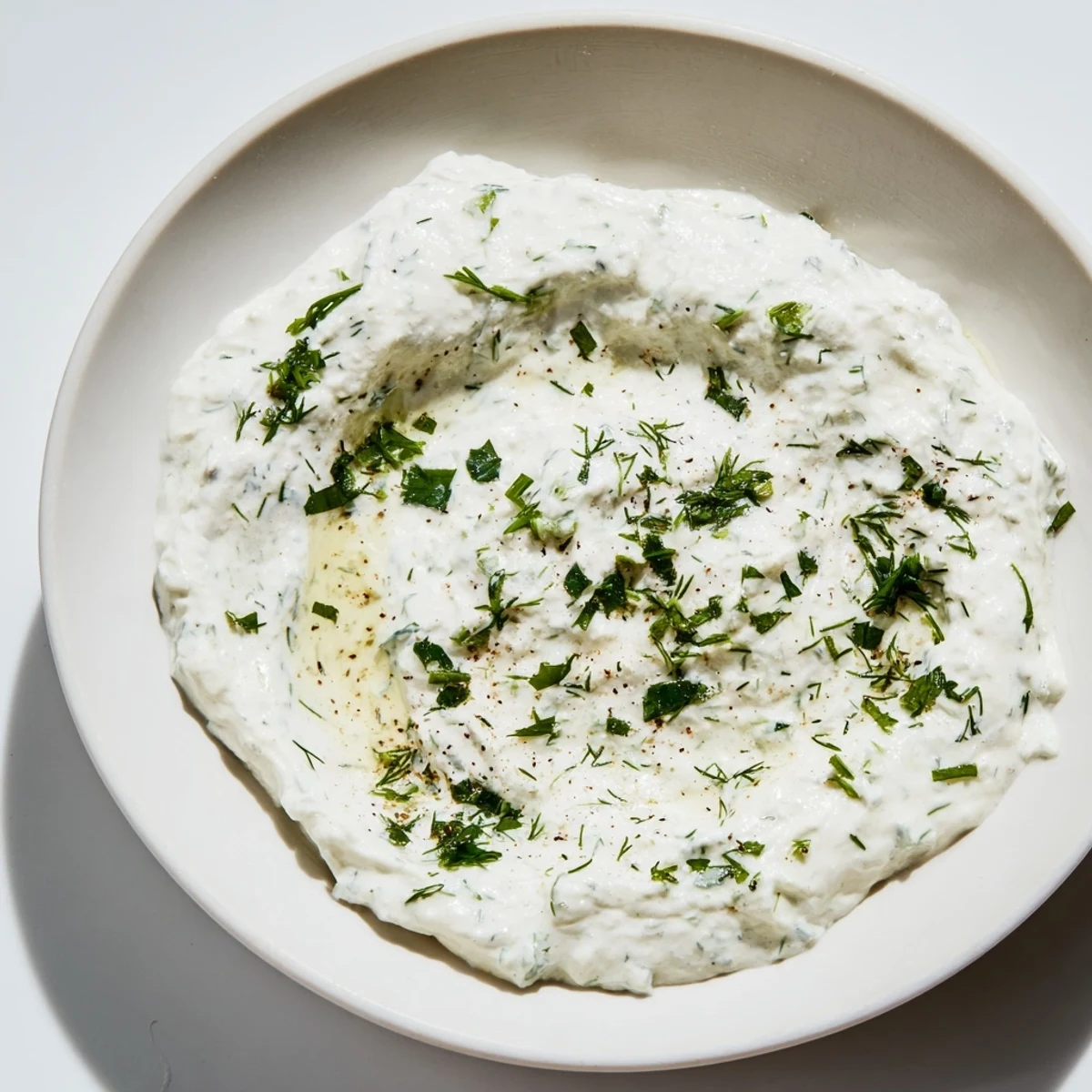 A vibrant photo shows Greek Yogurt Ranch Dip, ready to be scooped up with crunchy carrots.