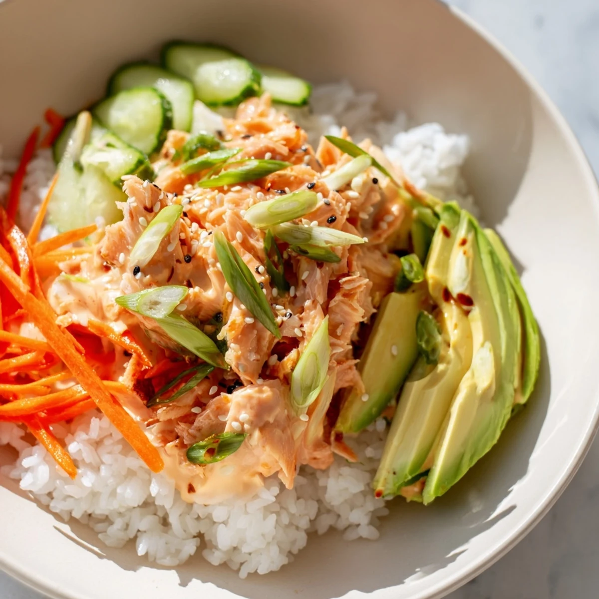 Steaming bowl of Spicy Canned Salmon Rice Bowl with colorful veggies, ready for a flavorful bite.