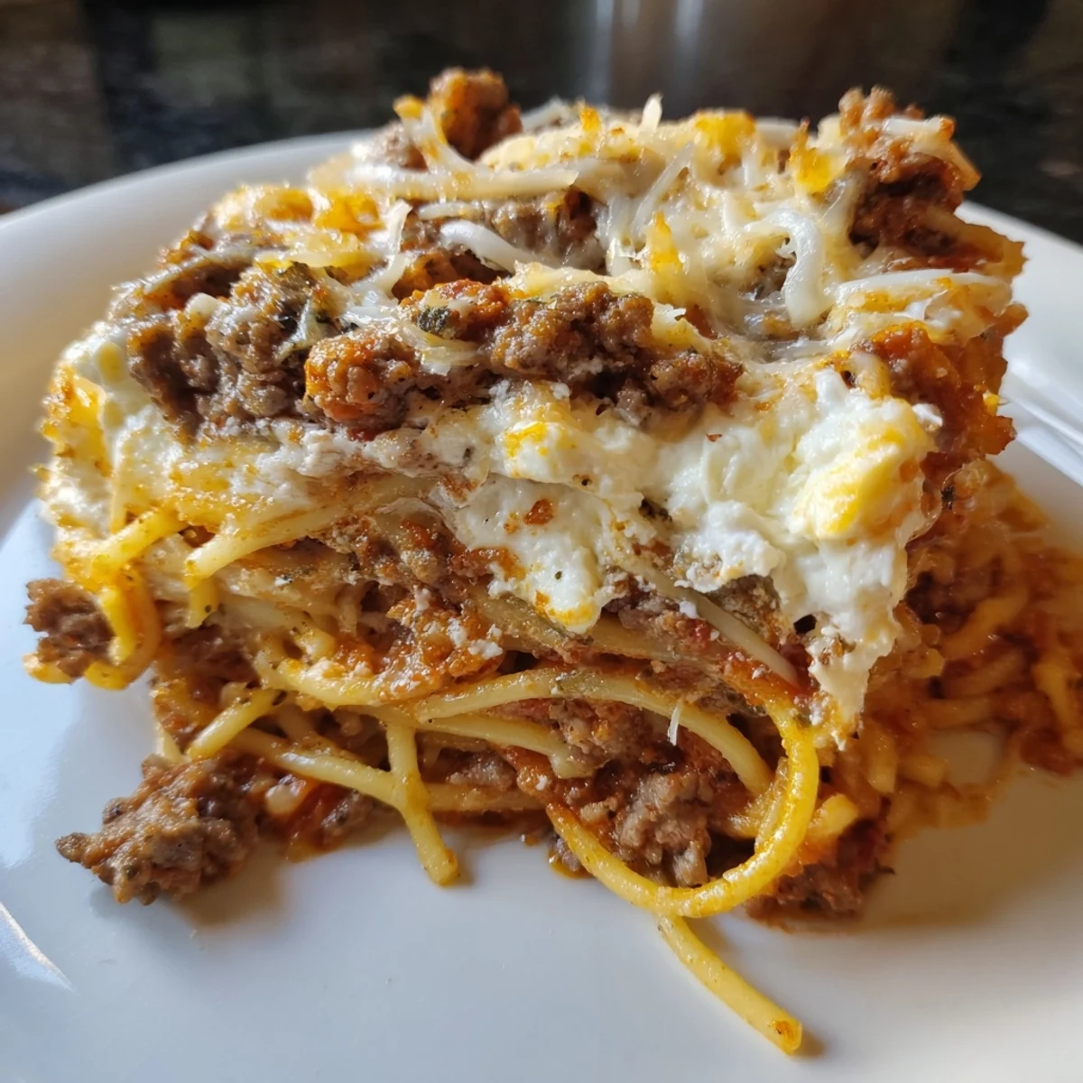 A satisfying, cheesy view of Million Dollar Spaghetti, ready to be served, a comforting family favorite.