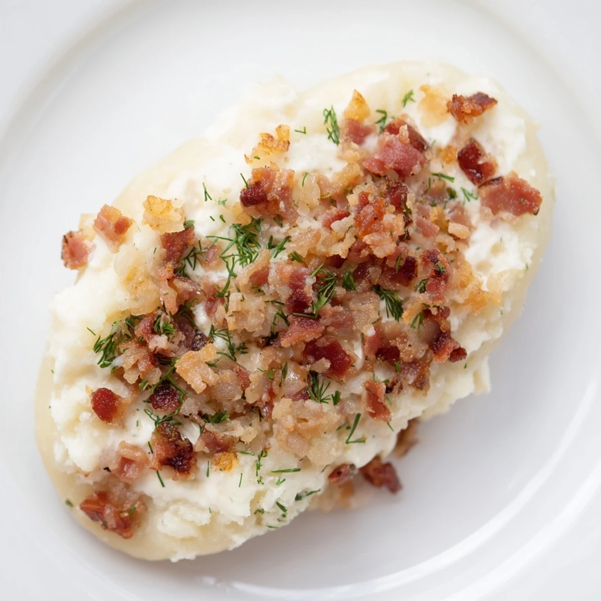 Steaming hot Lithuanian Cepelinai dumplings, bursting with savory meat, are covered in creamy sauce.