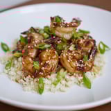 A beautiful close-up of ginger garlic shrimp bowls, showcasing tender shrimp and fresh green garnishes.