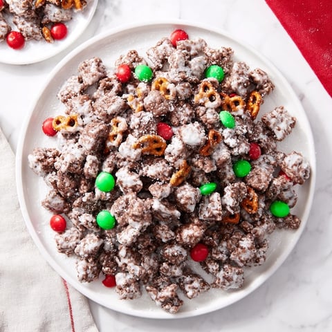 Golden-dusted Simplified Reindeer Chow mix: crunchy cereal coated in chocolate and peanut butter, ready to serve.
