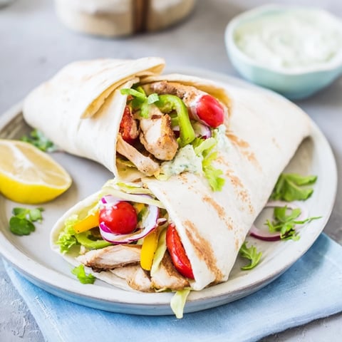 Sheet-Pan Fajita Chicken Rainbow Wraps, featuring savory chicken and colorful roasted veggies, ready to roll in warm tortillas.