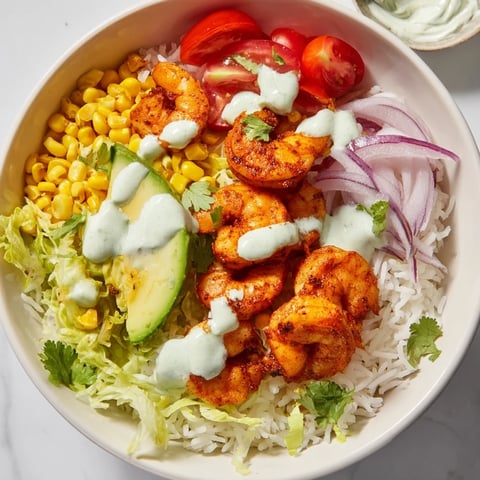 Cajun Shrimp Taco Bowls overflowing with vibrant colors: seasoned shrimp, rice, and fresh toppings.