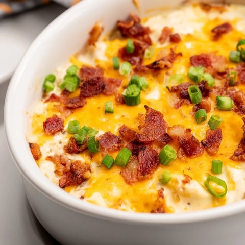 Cheesy Bacon Ranch Dip: A bubbling, golden-brown dip with crispy bacon and melted cheese, ready to serve.