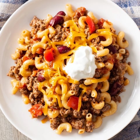 Steaming bowl of One-Pot Chili Mac, a comforting mix of tender pasta and savory chili flavors.