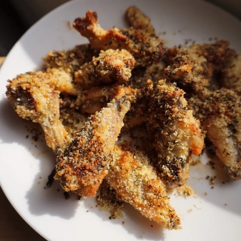 Golden, crispy Baked Parmesan Chicken Wings, ready to serve with ranch dressing and celery sticks.
