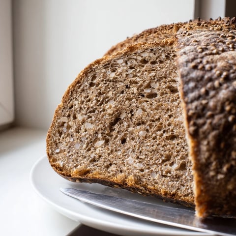 A rustic, dark Estonian Leib sourdough loaf, crusty and enticing, perfect with butter.