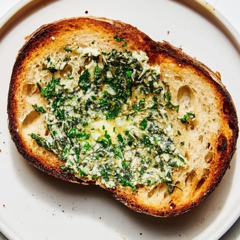 Herb Butter Toast glistens with melted compound butter on crisp artisan bread, flaky sea salt sparkling over fresh herbs.