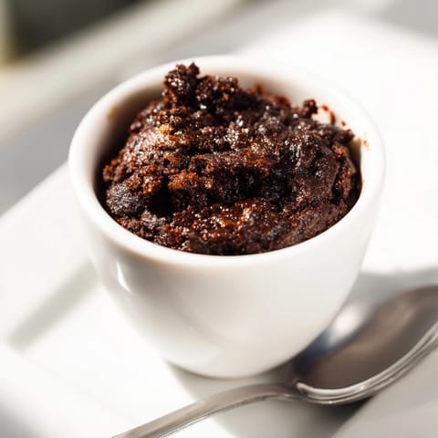 Easy one-minute Chocolate Mug Brownie recipe: decadent, single-serving dessert ready in a microwave.