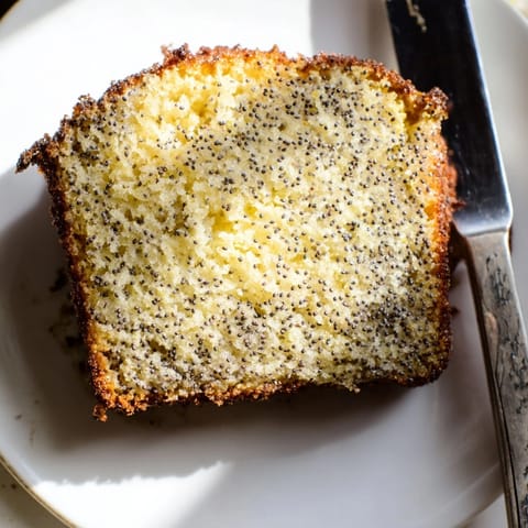 Golden Lemon Poppy Seed Loaf, fresh out of the oven, ready to slice.