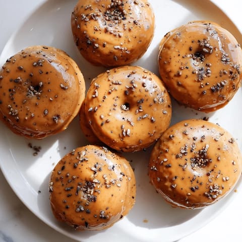 Decadent pancake donuts blend chai spices and coffee, drizzled with caramel.  