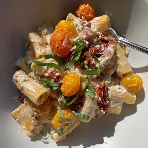 Delicious baked feta pasta topped with fresh basil and rich flavors.  