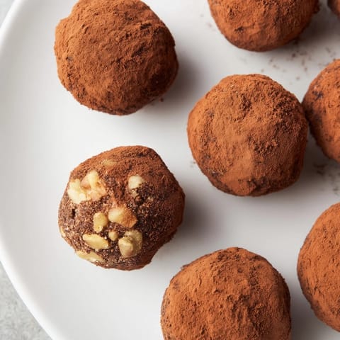 These Date & Walnut Truffles are ready to eat, with a rich flavor and cocoa-covered finish.