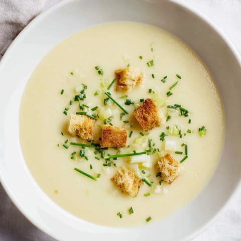 Golden-yellow potato leek soup, smooth and rich, perfect for a cozy, comforting lunch.