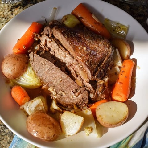 A close-up shot of the fork-tender Pickle Brine Pot Roast, slow-cooked to juicy perfection in a Dutch oven.