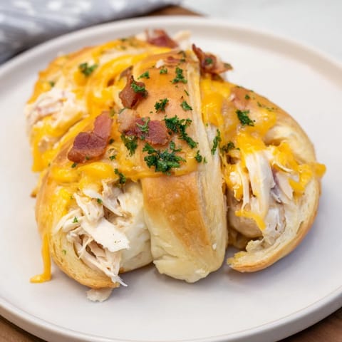 Warm, gooey cheese melting in these tasty Cheesy Chicken and Bacon Crescent Rolls, ready to enjoy.