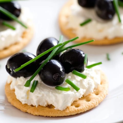 Close-up shot showcases the festive Gold Medal Olympic Ring Appetizers, featuring a creamy base topped with colorful bites.