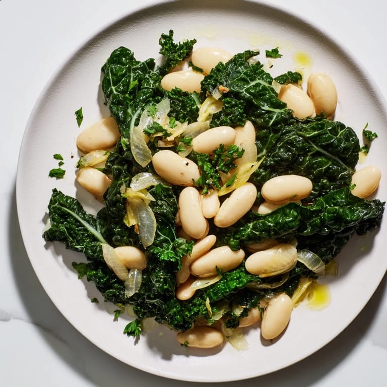 A close-up of the rustic Garlicky Beans with Winter Greens, showcasing tender greens and creamy beans.